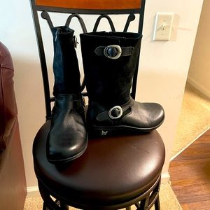 Algeria boots top is suede and the bottom is leather with buckles on the side.